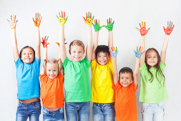 kids with painted hands in the air